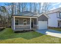 Newly built home with gray siding and a white garage door at 5618 Pine St, Charlotte, NC 28269