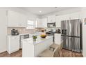 Well-lit kitchen featuring stainless steel appliances, an island, and ample counter space at 7324 Teague Dr, Gastonia, NC 28056