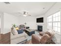 Comfortable living room with neutral tones, a ceiling fan, fireplace, and hardwood floors at 7324 Teague Dr, Gastonia, NC 28056