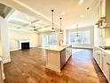 Modern open-concept kitchen featuring an island, stainless steel appliances, and sleek countertops at 7667 Maple Bluff Ln # 53, Concord, NC 28025