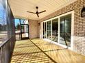 Screened porch features a ceiling fan and wood flooring, perfect for outdoor relaxation at 7667 Maple Bluff Ln # 53, Concord, NC 28025