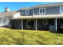 Back of home view showcasing a covered patio with lawn at 1017 21St Ne Ave, Hickory, NC 28601