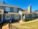 Charming two-story home with stone chimney and tidy landscaping enhancing its curb appeal at 1017 21St Ne Ave, Hickory, NC 28601