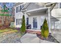 Inviting front porch with brick steps, two chairs, and landscaping at 1110 Kirkland Ct, Concord, NC 28025