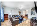 Spacious living room with leather furniture, hardwood floors, and a view into the dining area at 1110 Kirkland Ct, Concord, NC 28025