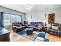 Living room with leather furniture, hardwood floors, and a ceiling fan at 1110 Kirkland Ct, Concord, NC 28025