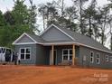 New construction home featuring a side entrance, hardiplank siding, and a spacious, unfinished yard at 211 Benfield Rd, Kings Mountain, NC 28086