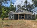Well-built home showcasing its side and front profile, complemented by a neatly kept lawn and natural surroundings at 211 Benfield Rd, Kings Mountain, NC 28086
