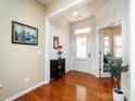 Bright foyer with hardwood floors, decorative trim, and a charming accent table and artwork at 21222 W Tern Ct, Fort Mill, SC 29707