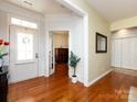 Elegant foyer featuring hardwood floors, a white front door with glass accents, and a view into the office at 21222 W Tern Ct, Fort Mill, SC 29707