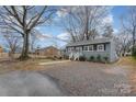 Gray house with gravel driveway, visible yard, and a tree at 225 Spencer St, Rock Hill, SC 29730