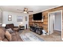 Living room with brown couches, a large TV, and wood wall at 225 Spencer St, Rock Hill, SC 29730