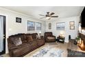 Living room with brown couches, a TV, and a wood accent wall at 225 Spencer St, Rock Hill, SC 29730