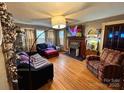 Cozy living room with hardwood floors, fireplace, and comfortable seating arrangement at 225 Wilson St, Albemarle, NC 28001