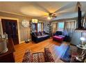 Comfortable living room featuring hardwood floors, an area rug, a couch, and an ottoman at 225 Wilson St, Albemarle, NC 28001