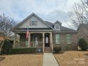 Brick ranch home with stone accents, covered porch, and landscaped yard at 240 Harrison Ln, Locust, NC 28097