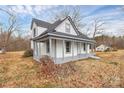 Charming two-story house with a covered porch, perfect for relaxing outdoors at 2520 Lower Stone Church Rd, Rockwell, NC 28138