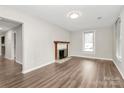 Bright living room featuring a classic fireplace and warm wood flooring at 2520 Lower Stone Church Rd, Rockwell, NC 28138