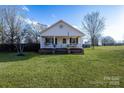 White house with a porch, brick base, and American flag at 2961 Great Falls Hwy, Lancaster, SC 29720