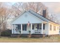 White house with a porch and lush landscaping at 2961 Great Falls Hwy, Lancaster, SC 29720