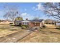 Ranch house with a large yard and driveway, offering curb appeal at 3003 River Rd, Shelby, NC 28152