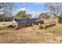 Brick house showcasing a backyard with a fence and patio at 3003 River Rd, Shelby, NC 28152