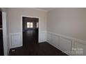 Bright dining room with dark hardwood floors and wainscoting at 3015 Buffet Ln, Monroe, NC 28110