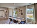 Modern dining area with a white table and four chairs, large windows, and wall decor at 3048 Ora Smith Rd, Lincolnton, NC 28092