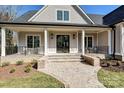 Close-up of the front entrance featuring a brick walkway, covered porch, and black-framed glass doors at 3319 Gresham Pl, Charlotte, NC 28211