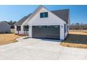 New construction home with gray garage door and driveway at 343 North Brook Iii School Rd, Vale, NC 28168