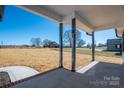 Covered front porch with view of the backyard and trees at 343 North Brook Iii School Rd, Vale, NC 28168