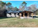 Brick ranch home with covered porch and landscaped lawn at 4165 Laurelwood Ct, Concord, NC 28025