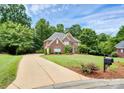 Brick home with a long driveway and lush landscaping at 508 Cobbs Glen Ct, Rock Hill, SC 29732