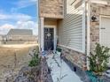 Inviting front door entrance with stone accents, landscaping, and a decorative 'HOME' sign at 571 Palmarosa St # 130, Fort Mill, SC 29715