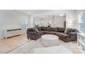 Spacious living room with gray sectional sofa and light wood floors at 693 Candela Ct, York, SC 29745