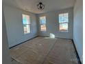 Bright bedroom with three windows and a modern ceiling light fixture at 8704 Sherrills Ford Rd, Sherrills Ford, NC 28673