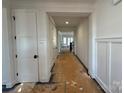 Bright hallway featuring white trim and doors and a view of the stairs at 8704 Sherrills Ford Rd, Sherrills Ford, NC 28673