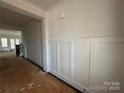 Hallway with white wainscoting and natural light at 8704 Sherrills Ford Rd, Sherrills Ford, NC 28673