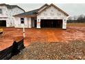 New construction home with Tyvek wrap, awaiting finishing touches and landscaping in a promising neighborhood at 1012 Farm Branch Ct, Indian Trail, NC 28079