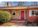 Front porch detail, red door, brick and stone exterior at 147 W Mcneely Ave, Mooresville, NC 28115