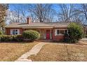 Red brick ranch house with a covered porch and landscaping at 147 W Mcneely Ave, Mooresville, NC 28115