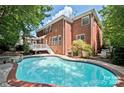 Backyard features a refreshing in-ground pool, perfect for outdoor relaxation and entertainment at 15613 Glen Miro Dr, Huntersville, NC 28078