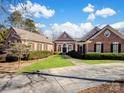 Charming brick home with manicured lawn, mature landscaping, and inviting driveway at 1629 Southpoint Ln, New London, NC 28127