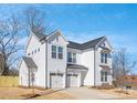 Stunning white home featuring a two-car garage, impeccable design, and modern architectural elements at 1739 Dunloe St # 8242, Charlotte, NC 28206