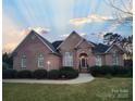 Brick home with landscaped yard and walkway at 210 Classic Ct, Mount Holly, NC 28120