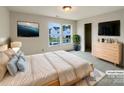 Virtually staged main bedroom with large windows and dresser at 3418 Pikes Peak Dr, Gastonia, NC 28052