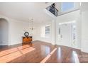 Bright foyer with hardwood floors, high ceilings, chandelier, and wainscoting at 346 Almora Loop, Mooresville, NC 28115