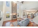 Inviting living room with floor-to-ceiling stone fireplace, large windows, and open floor plan at 346 Almora Loop, Mooresville, NC 28115