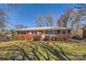 Charming brick home featuring a well-maintained lawn and neat landscaping at 4017 Leeds Dr, Charlotte, NC 28205