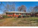 Charming brick home with manicured lawn and classic architectural details at 4017 Leeds Dr, Charlotte, NC 28205